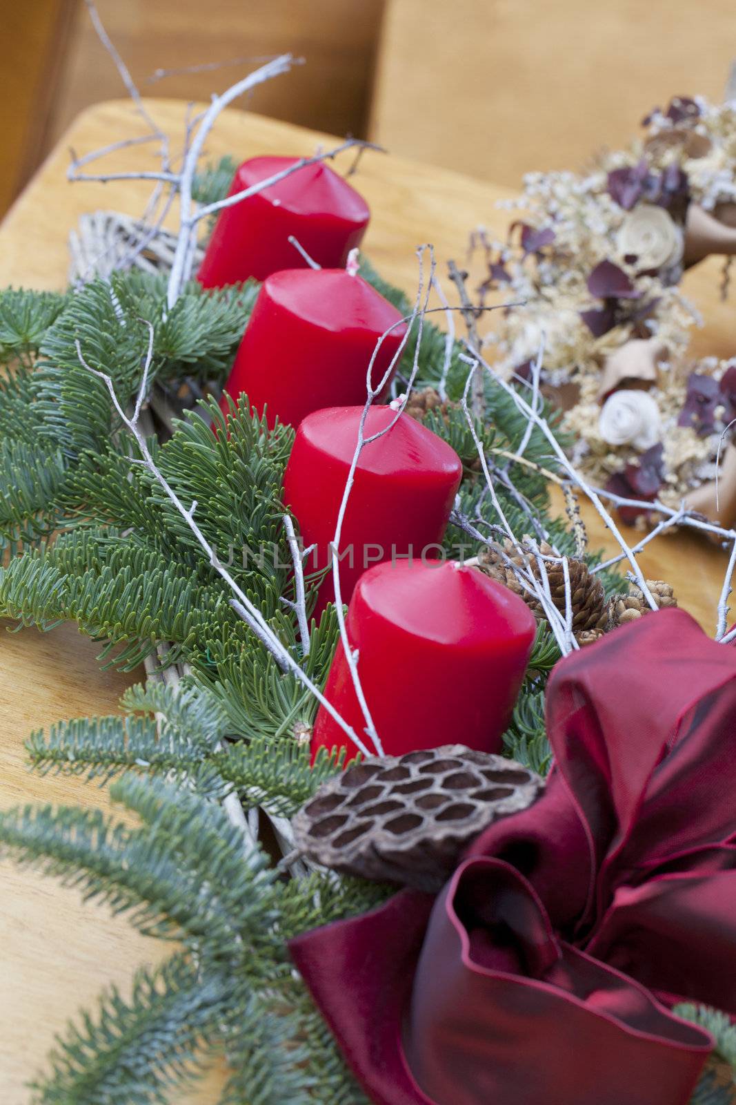 A Christmas decoration with four big red candles