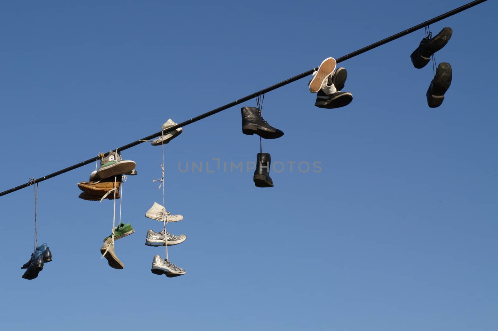 Shoes hanging on a cable by anderm