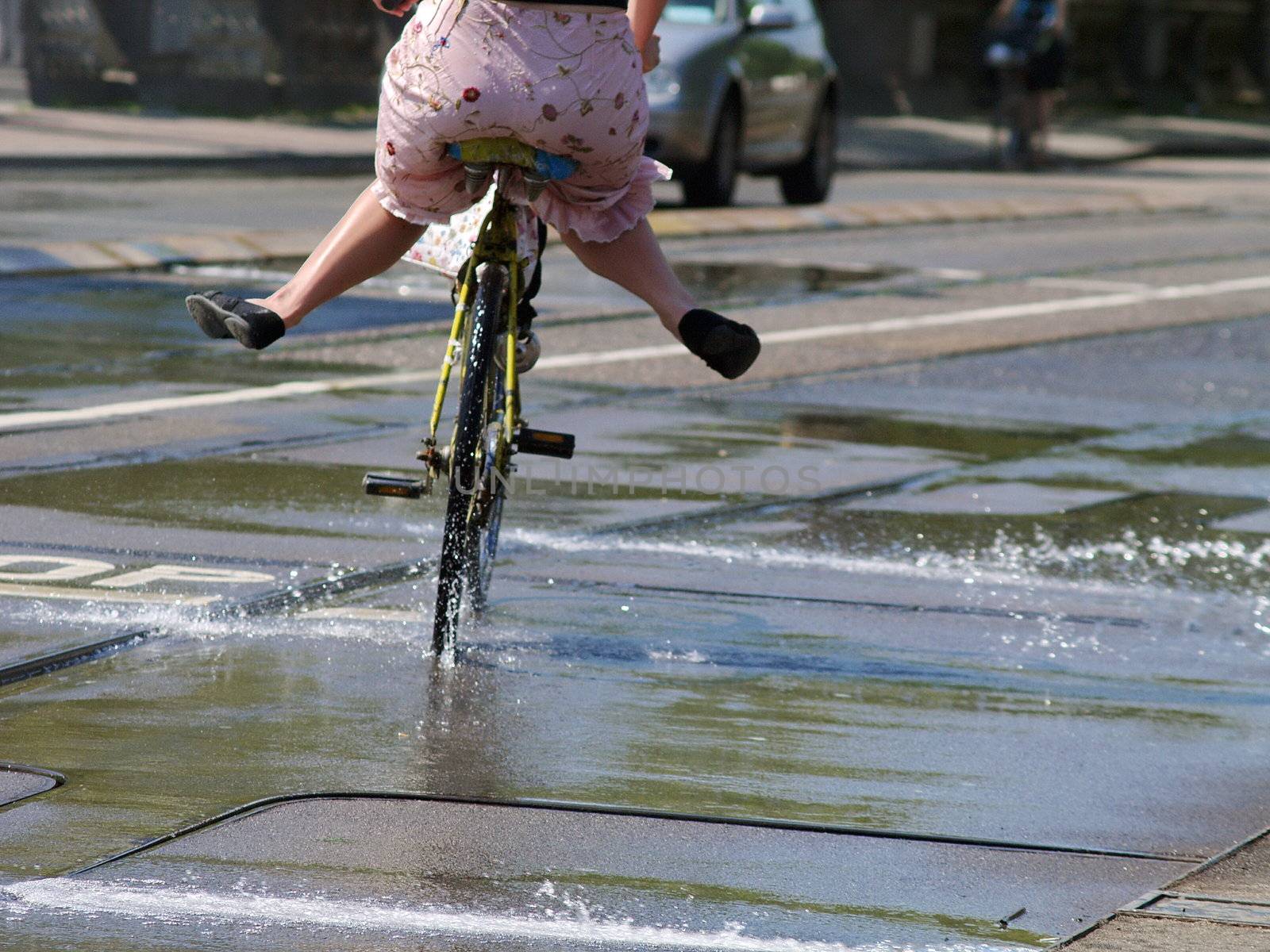 Woman bicycling into water by anderm