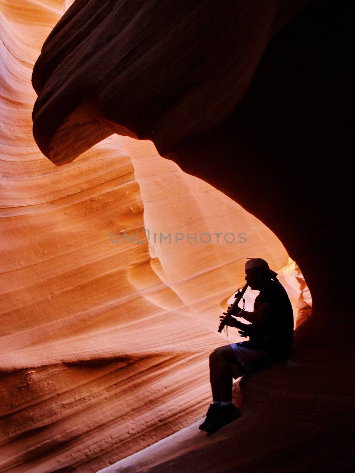 Navajo inidian playin on flute in Antelope Canyon by anderm