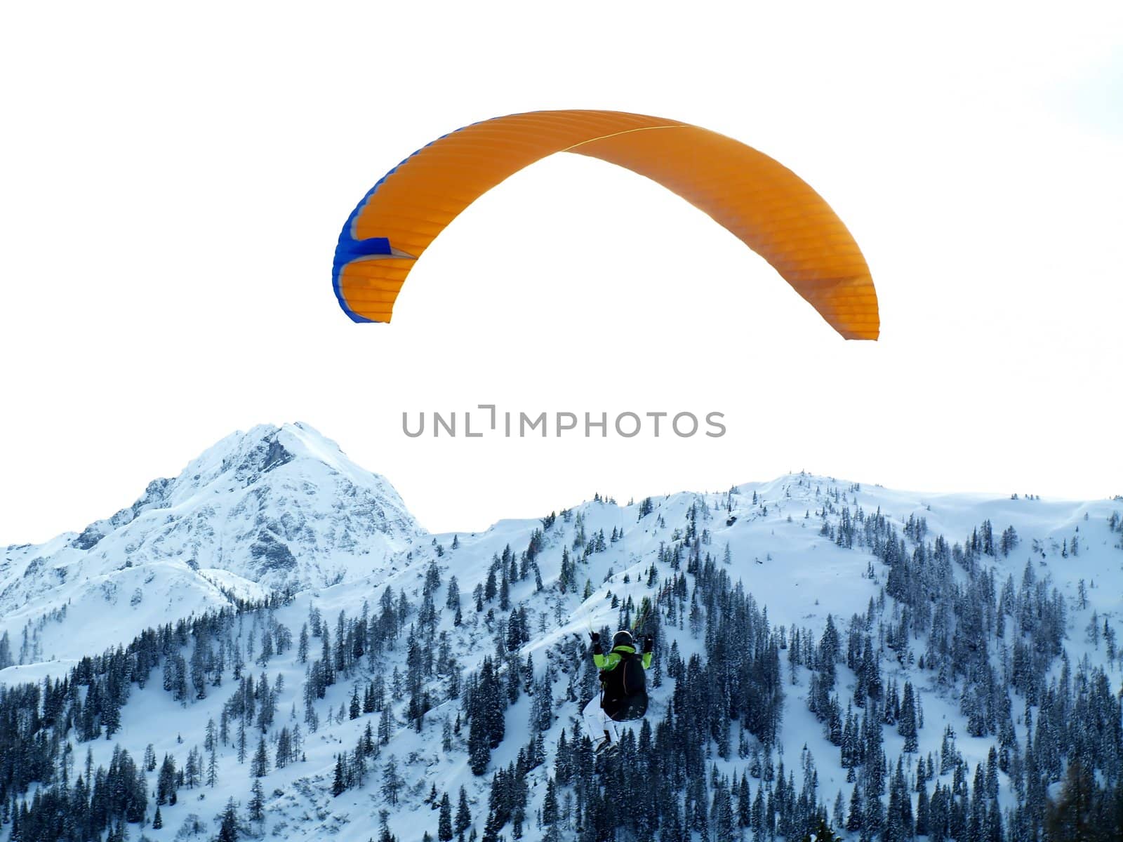 Paraglider with snowy mountain in the background.