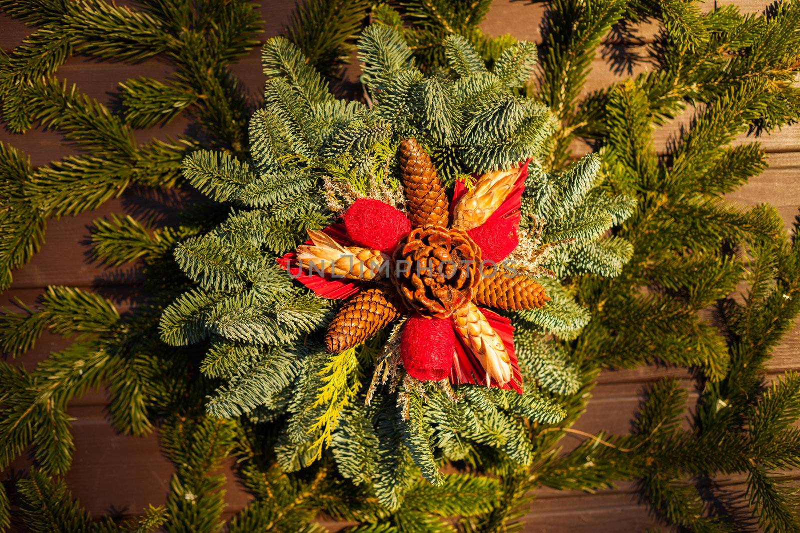 Decorative Christmas wreath of pointsetta, pine cones, evergreen