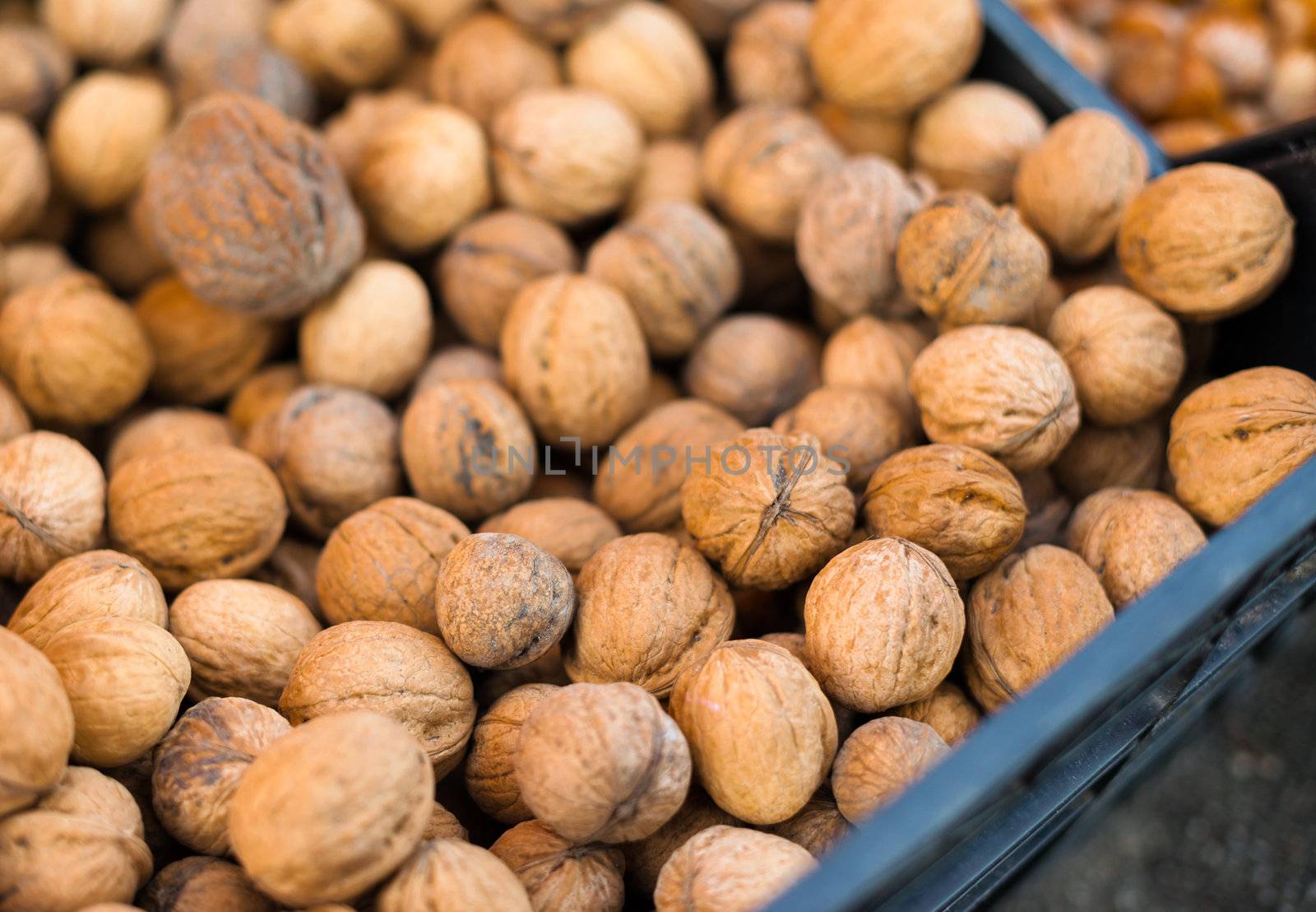 Walnuts in a full bin at a market