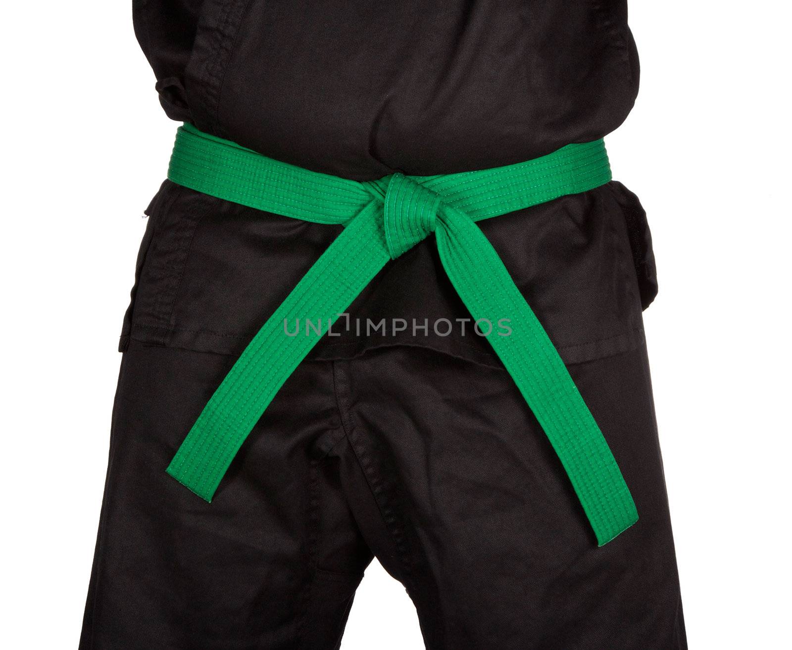 Karate green belt tied around marital artists torso wearing black dojo GI's.