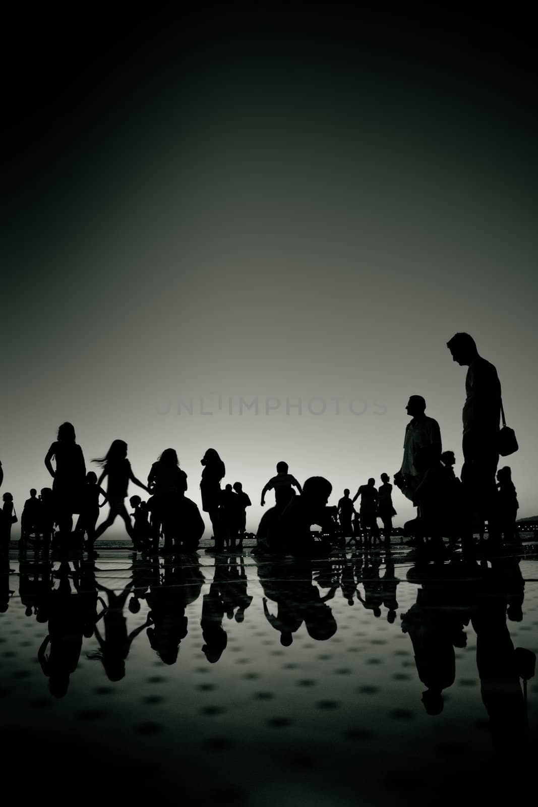 People silhouette reflections black and white on Zadar greetings to the Sun installation, Croatia