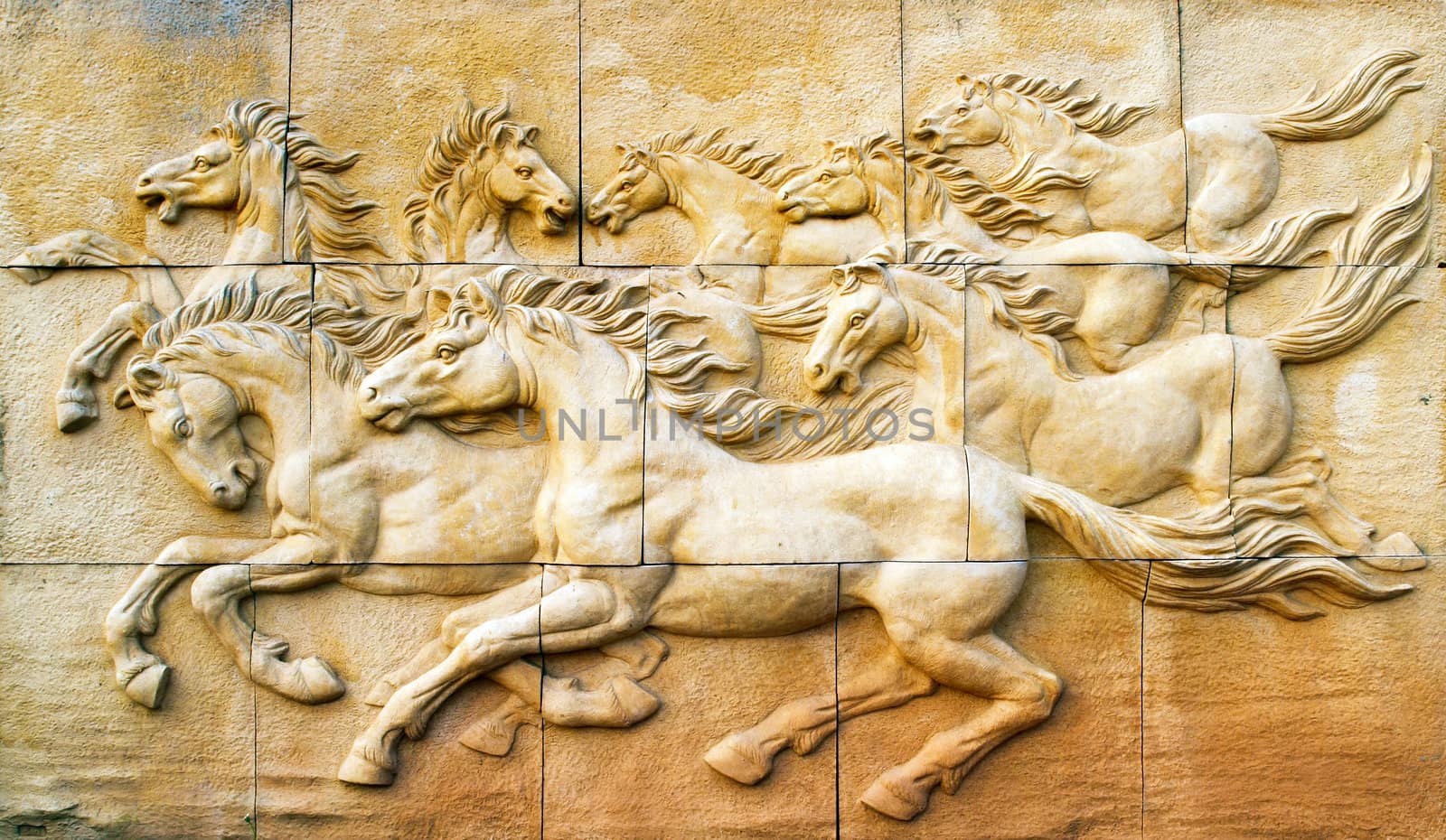 Stone sculpture of horse on wall by geargodz