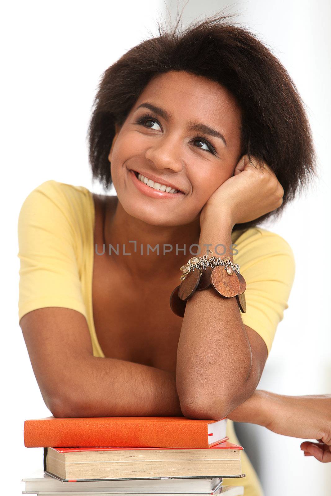 Young and beautiful afro woman studying with books