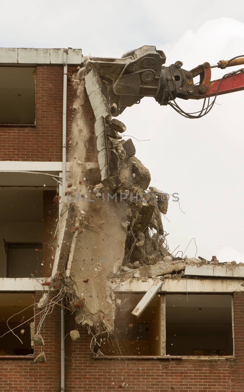 A crane is demolishing a block of flats