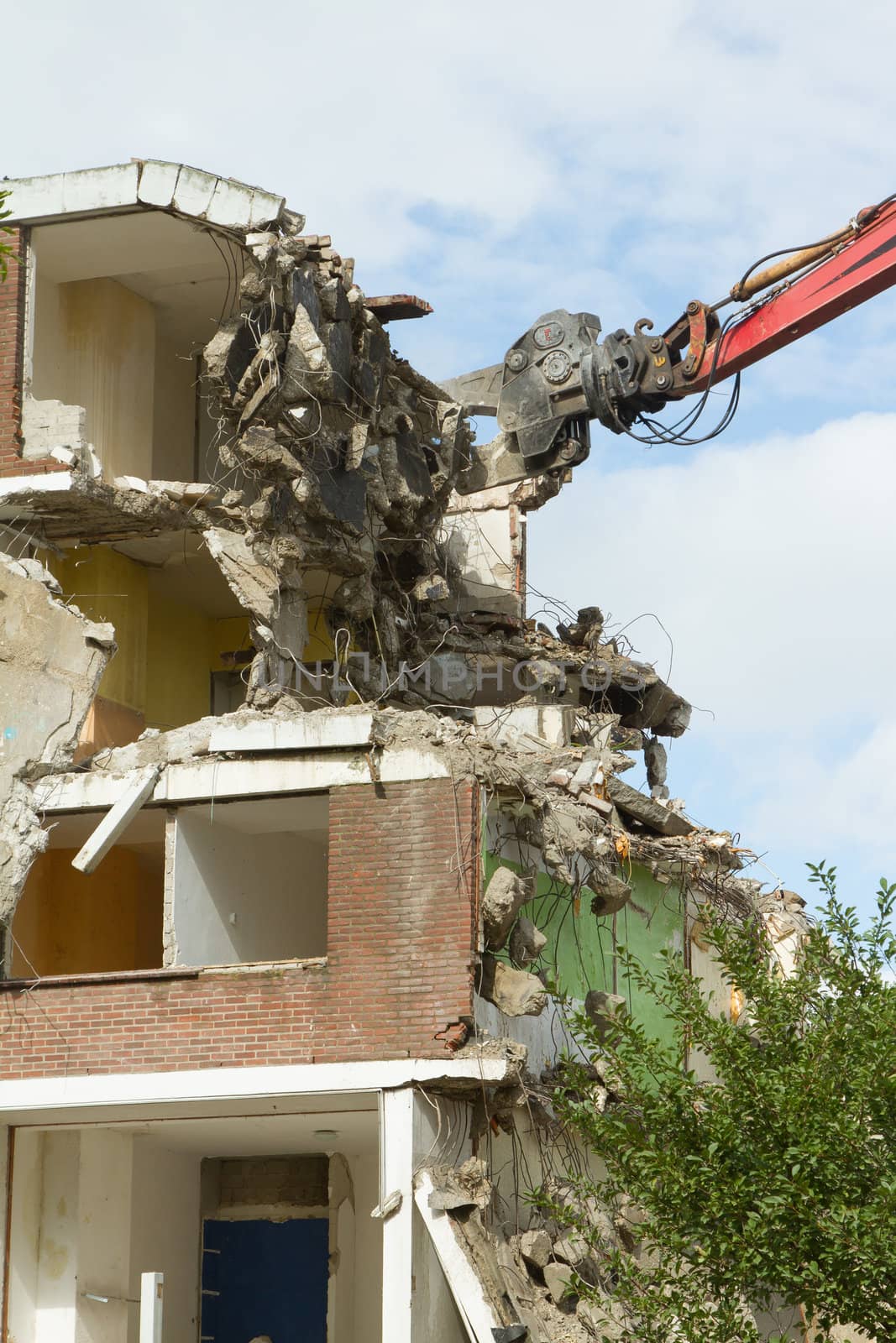 A crane is demolishing a block of flats