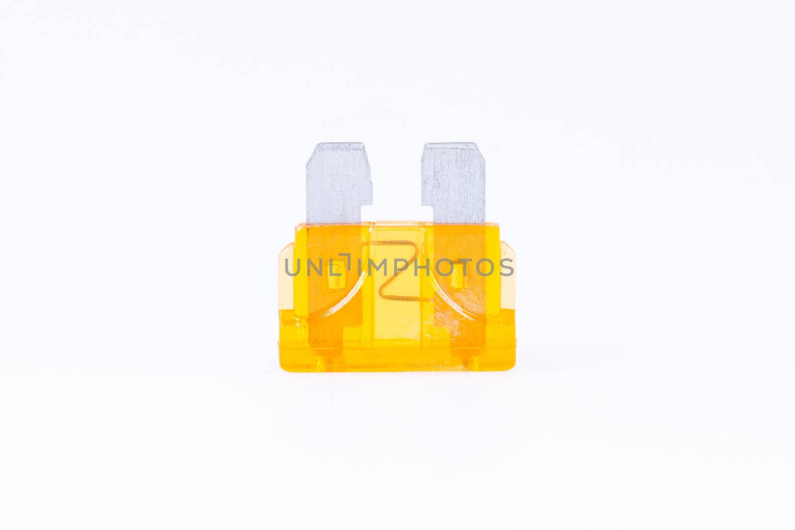 An orange car fuse with a white background