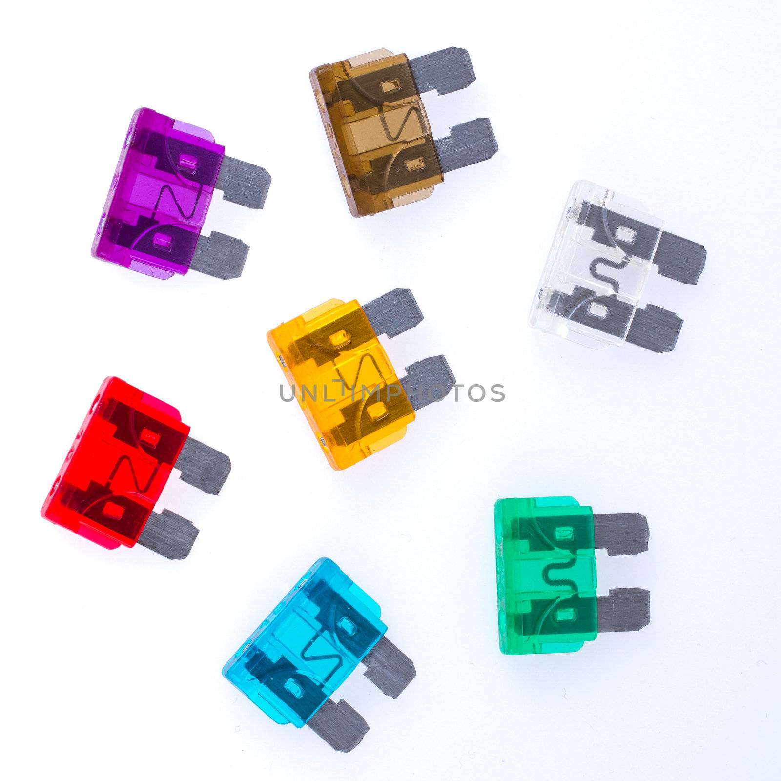Different colors of  car fuses with a white background