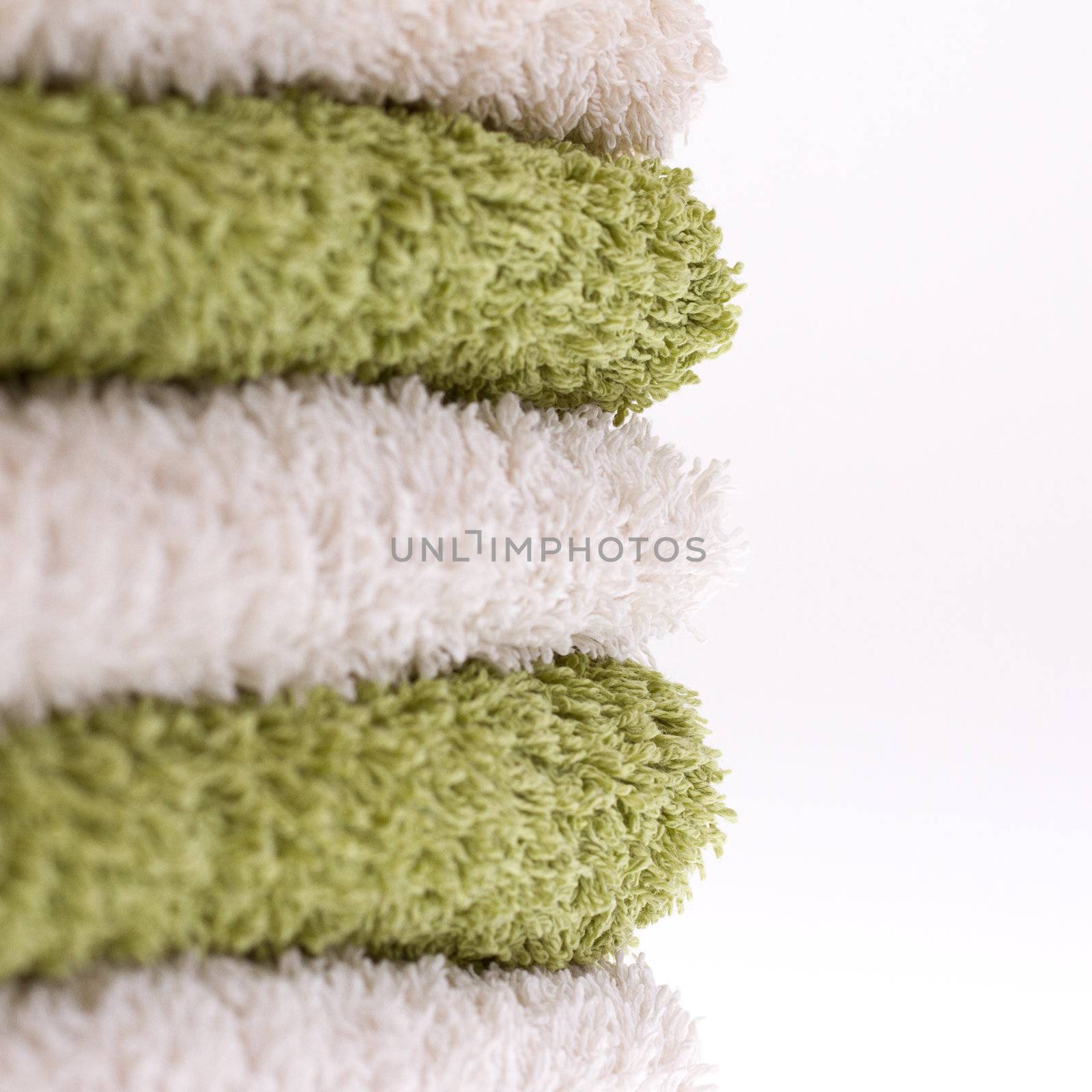 A pile of green and white towels