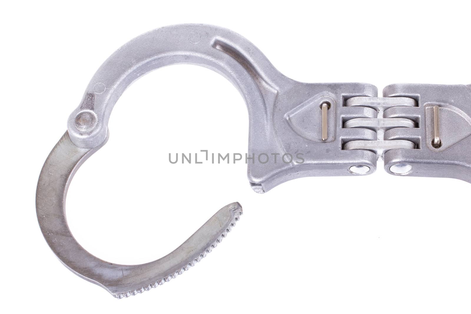 A close-up of metal handcuffs isolated on a white background