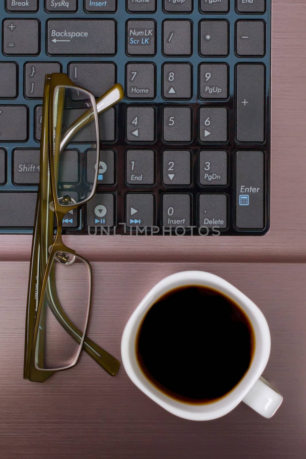 Espresso coffee with glasses on a laptop