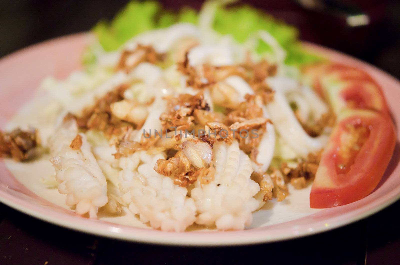 deep fried  octopus with fried garlic and fresh vegetable