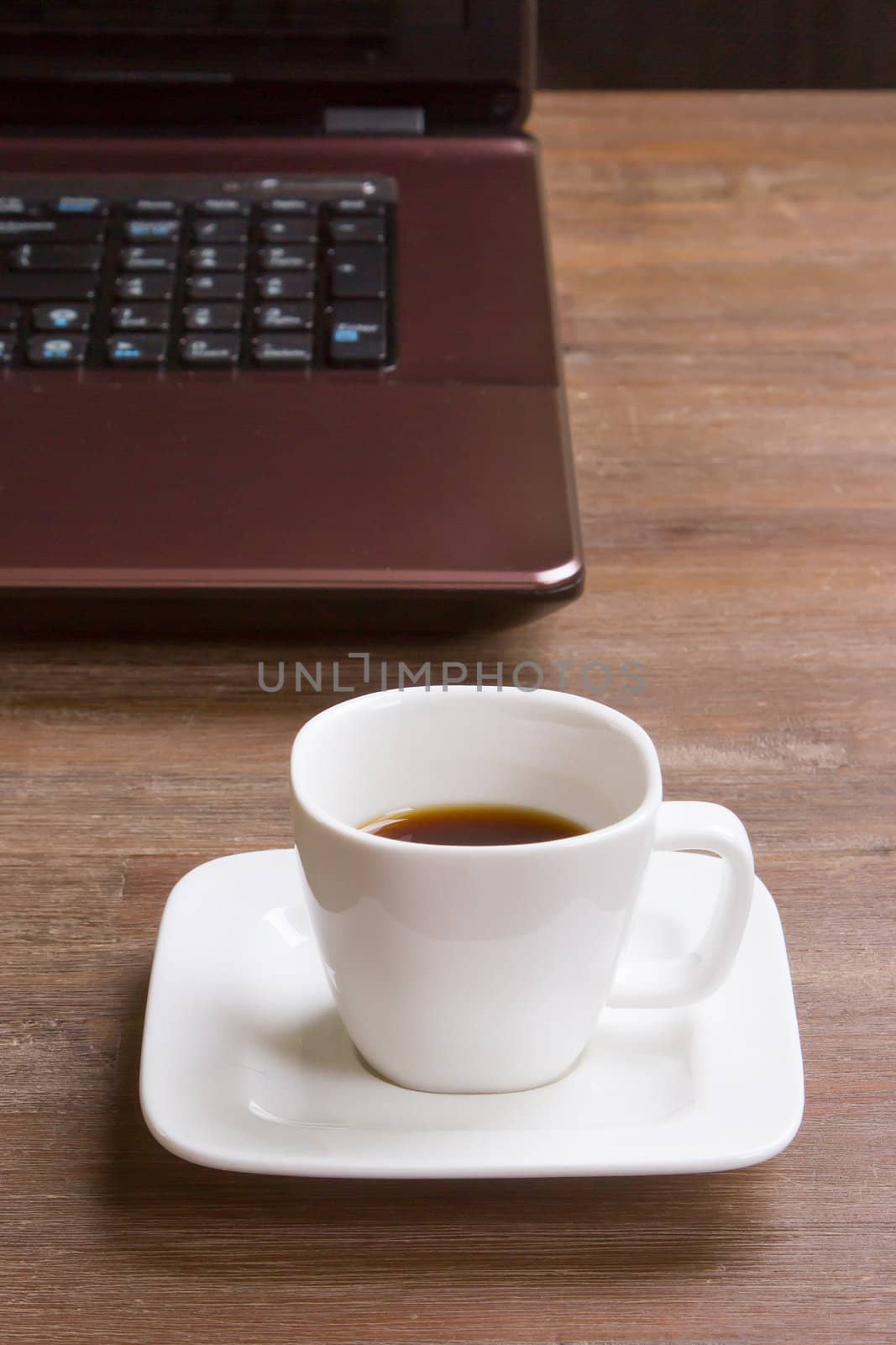 Espresso coffee on wood floor with laptop