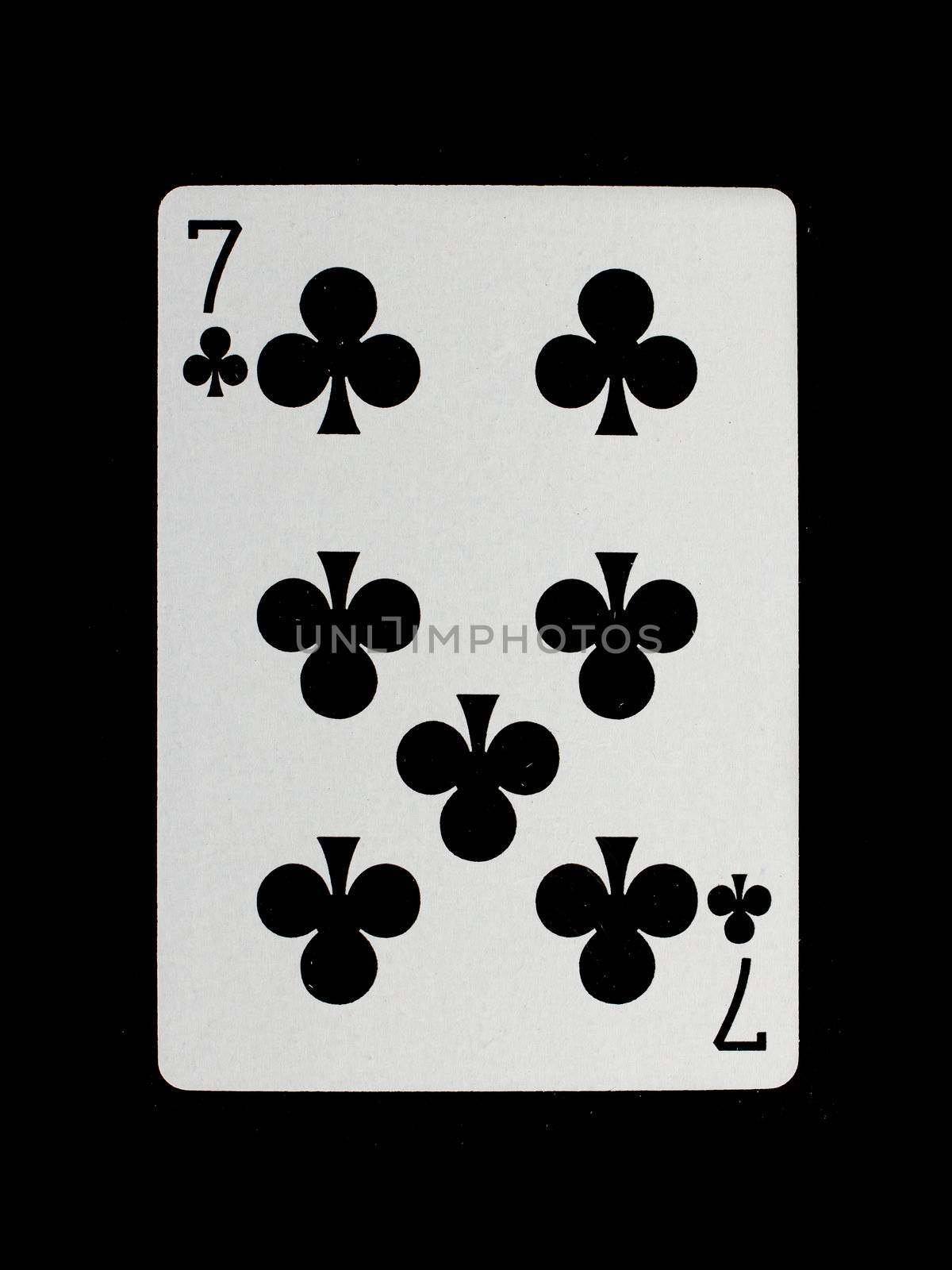 Playing card (seven) isolated on a black background