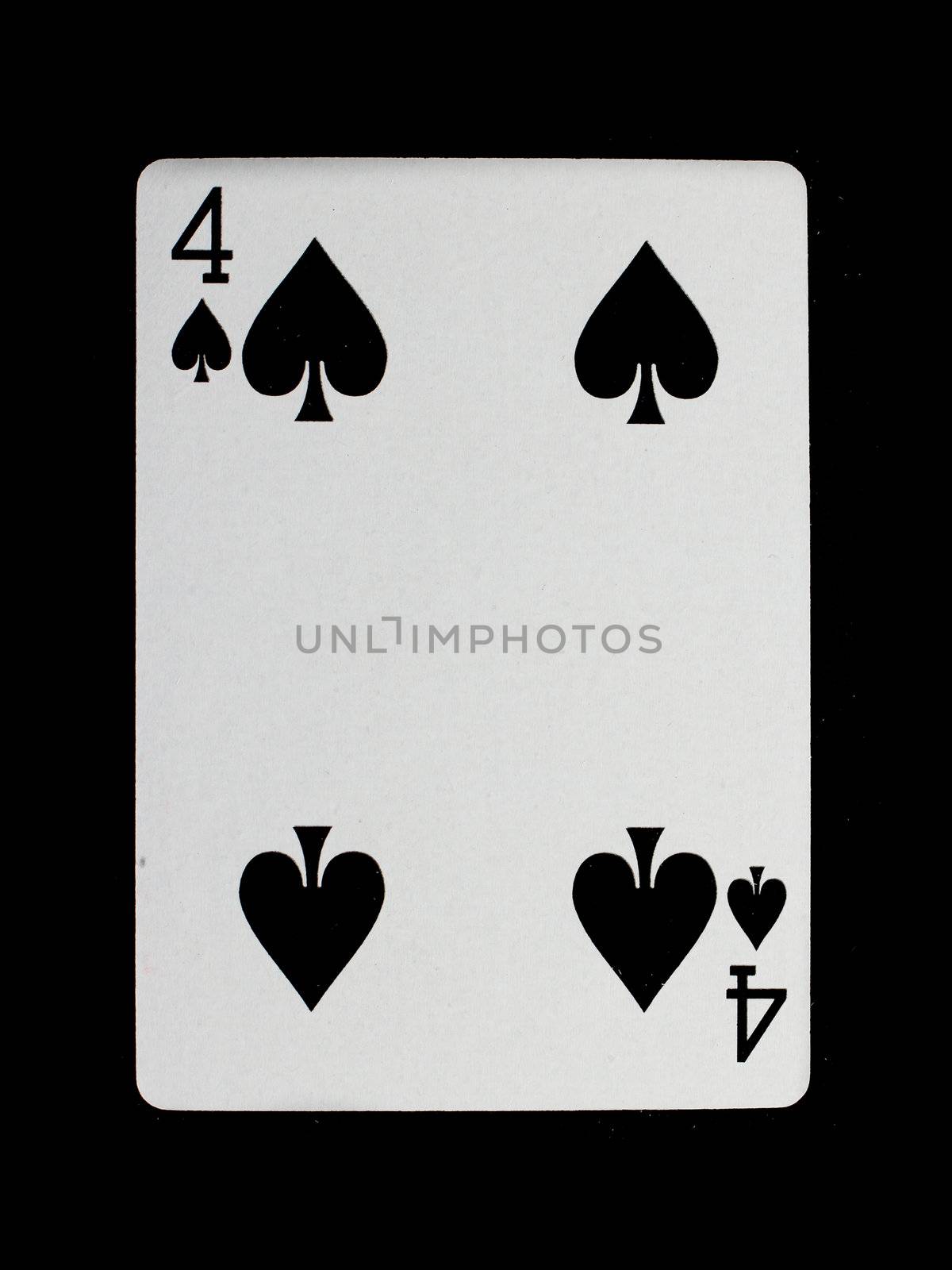 Old playing card (four) isolated on a black background