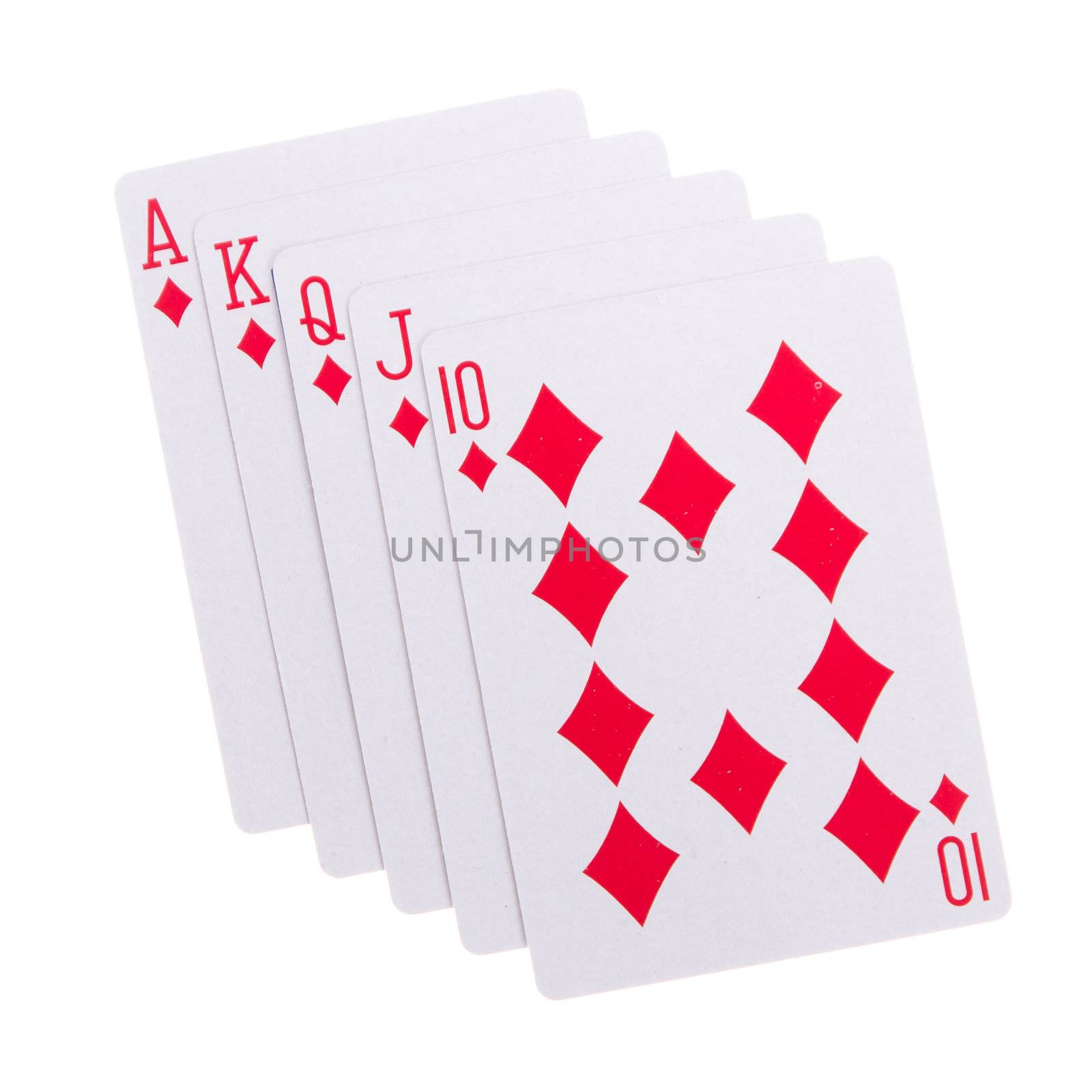 Old playing cards (royal flush) isolated on a red background