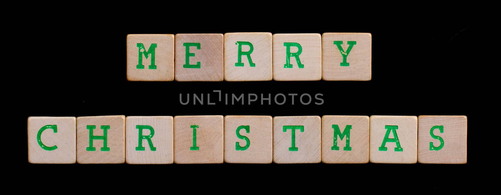 Green letters on old wooden blocks (merry christmas)