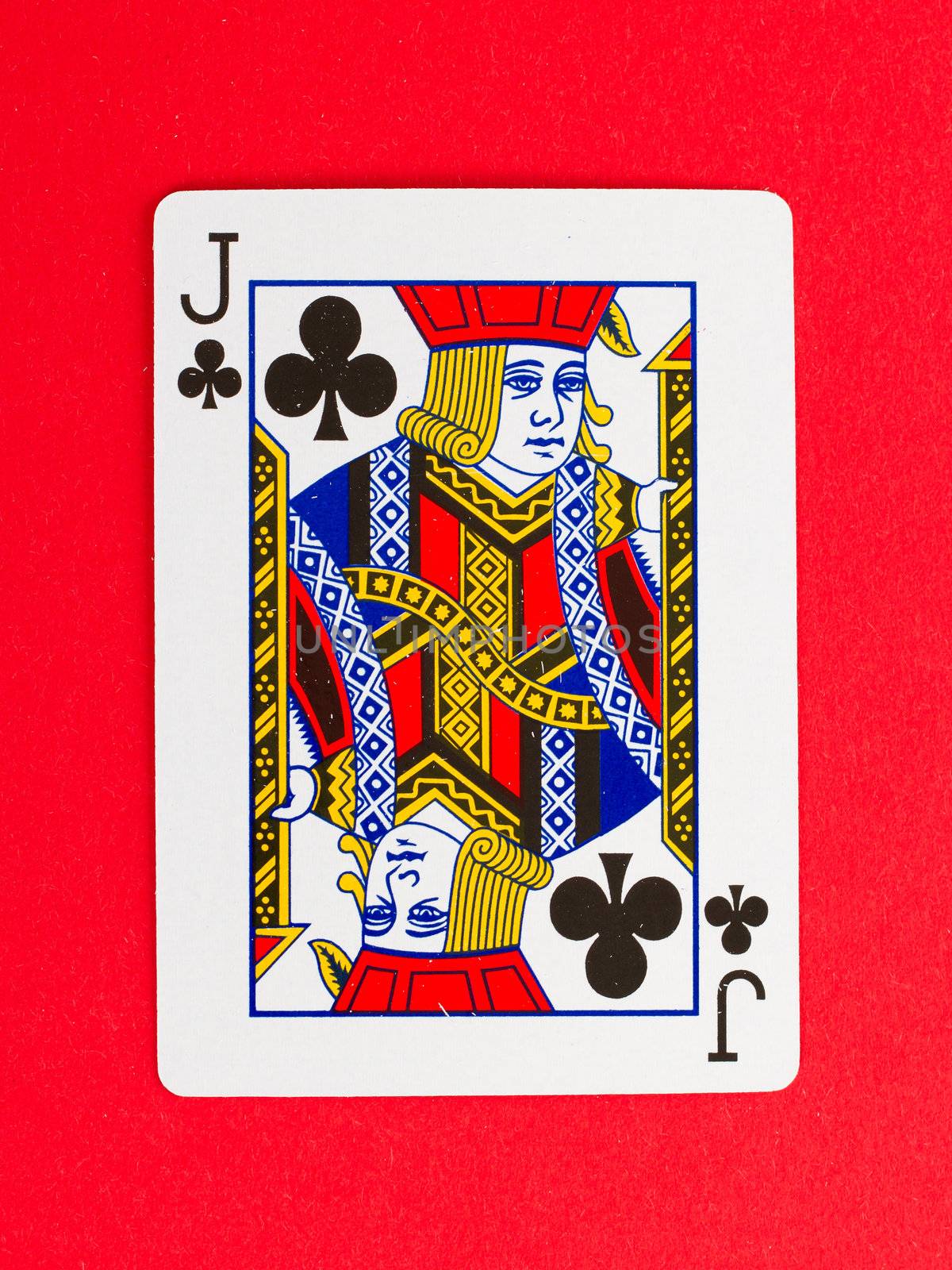 Old playing card (jack) isolated on a red background