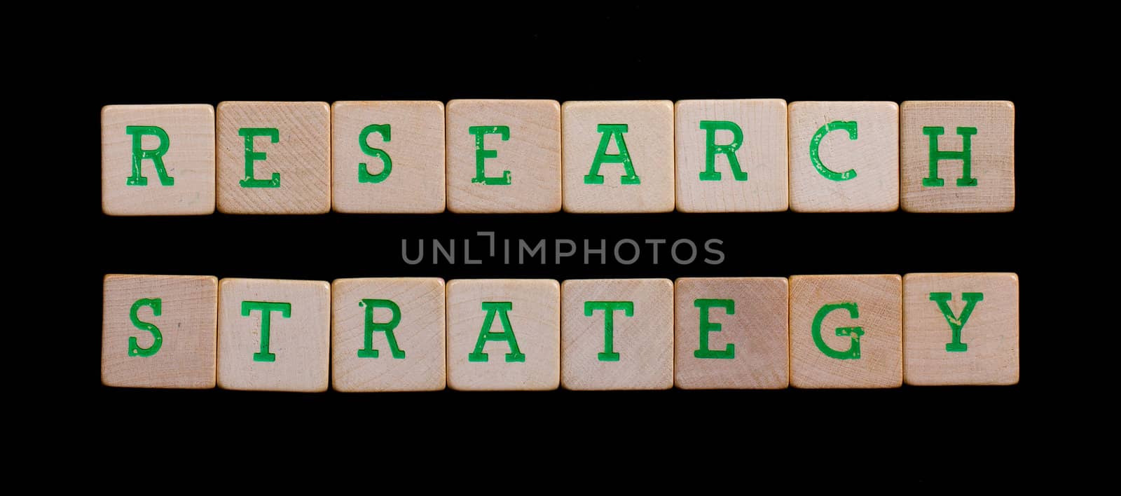 Green letters on old wooden blocks (research, strategy)