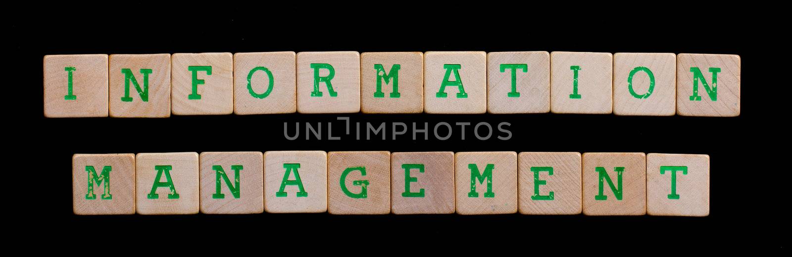 Green letters on old wooden blocks (information management) by michaklootwijk