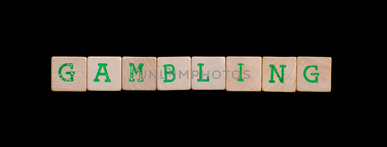 Green letters on old wooden blocks (gambling)