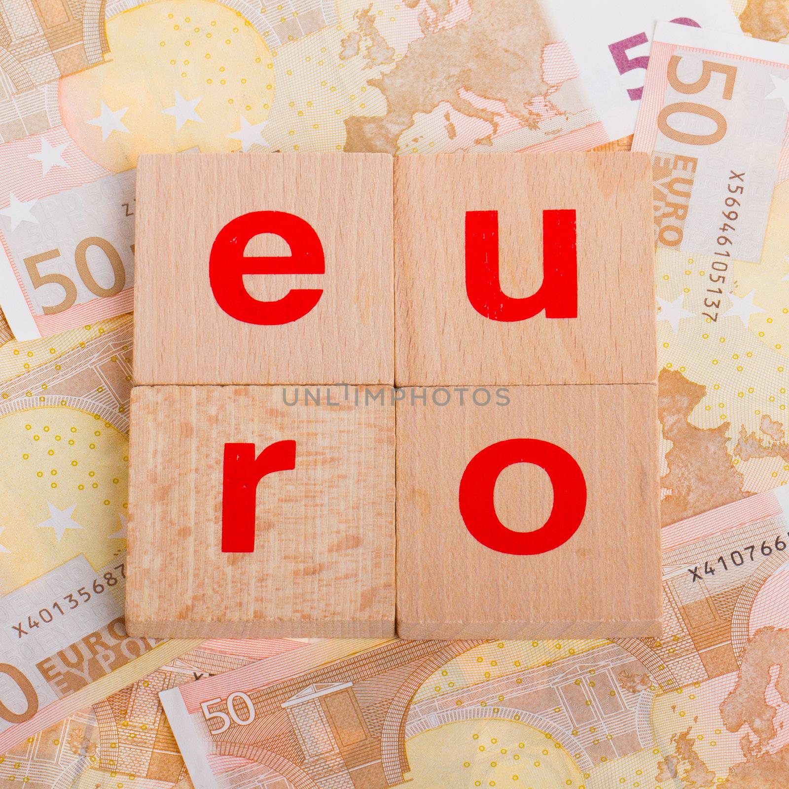 Letter on blocks on top of some 50 euro banknotes