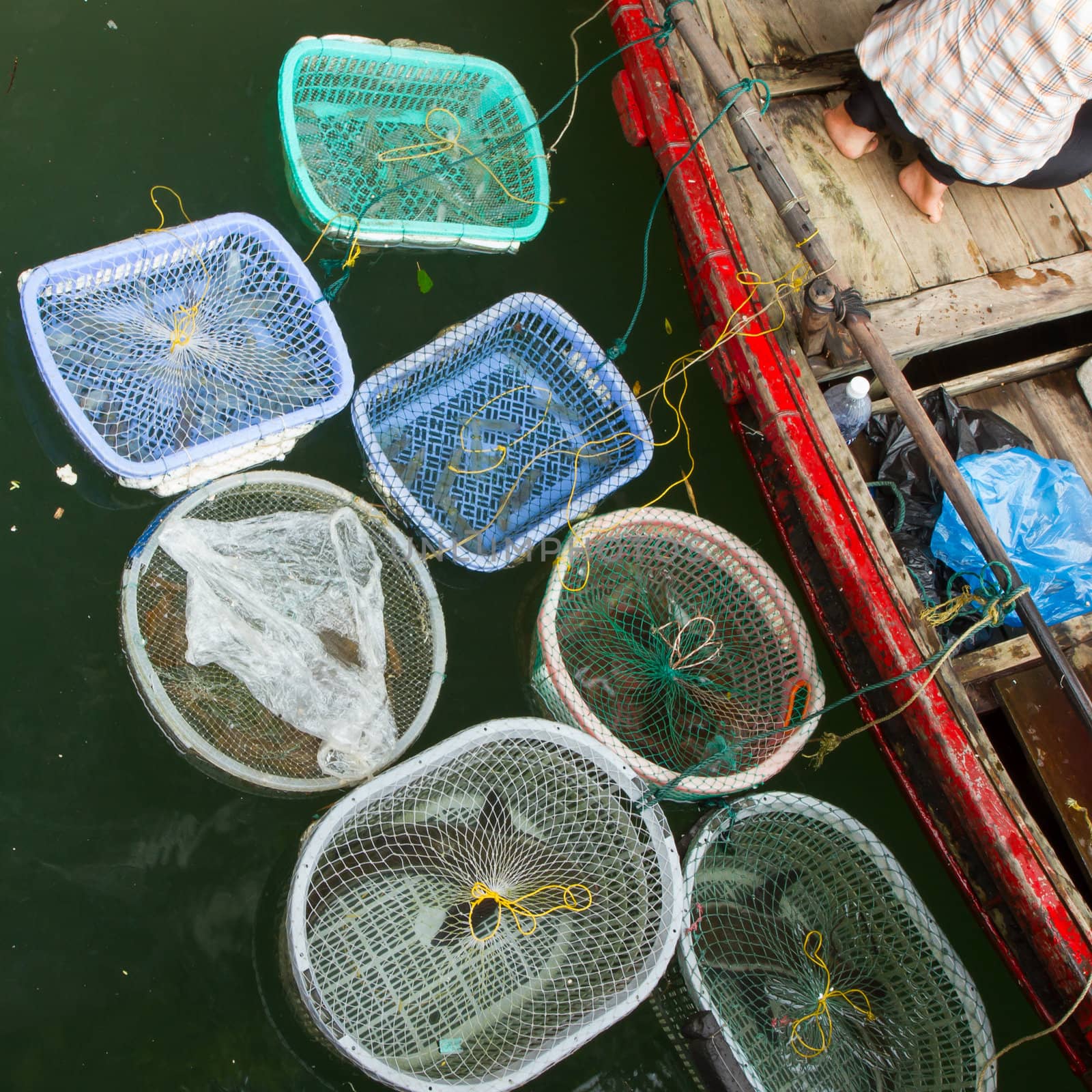 HA LONG BAY, VIETNAM AUG 10, 2012 - Food seller in boat. Many Vi by michaklootwijk