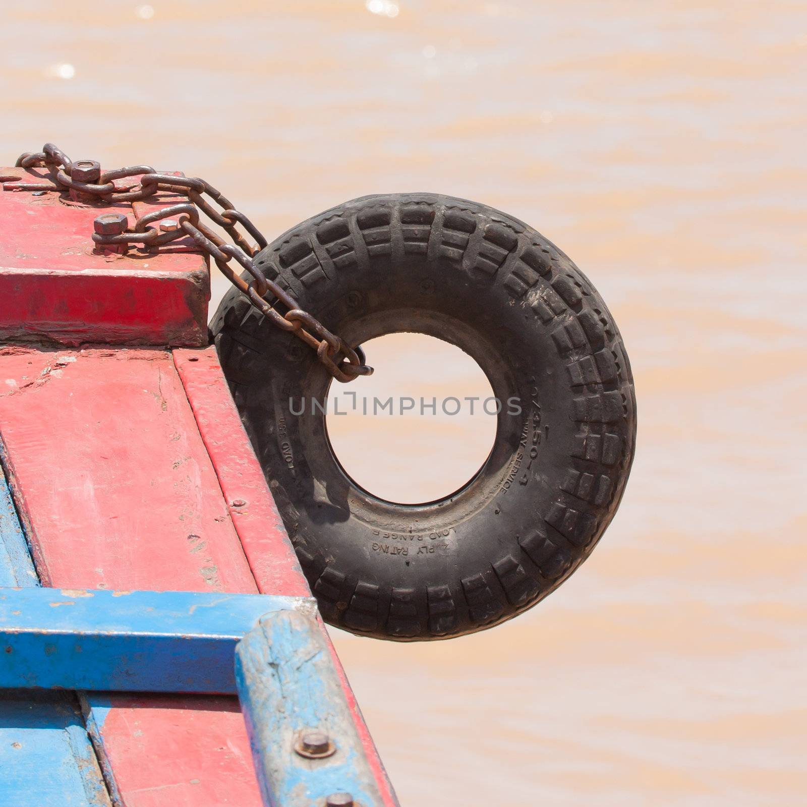 Fender on a red boat in the Mekong delta by michaklootwijk