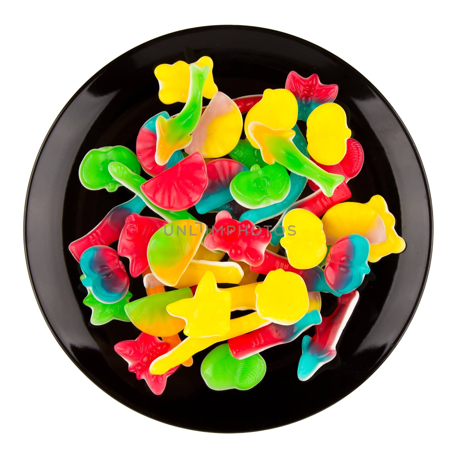 Colorful candies in many different shapes isolated on a black pl by michaklootwijk