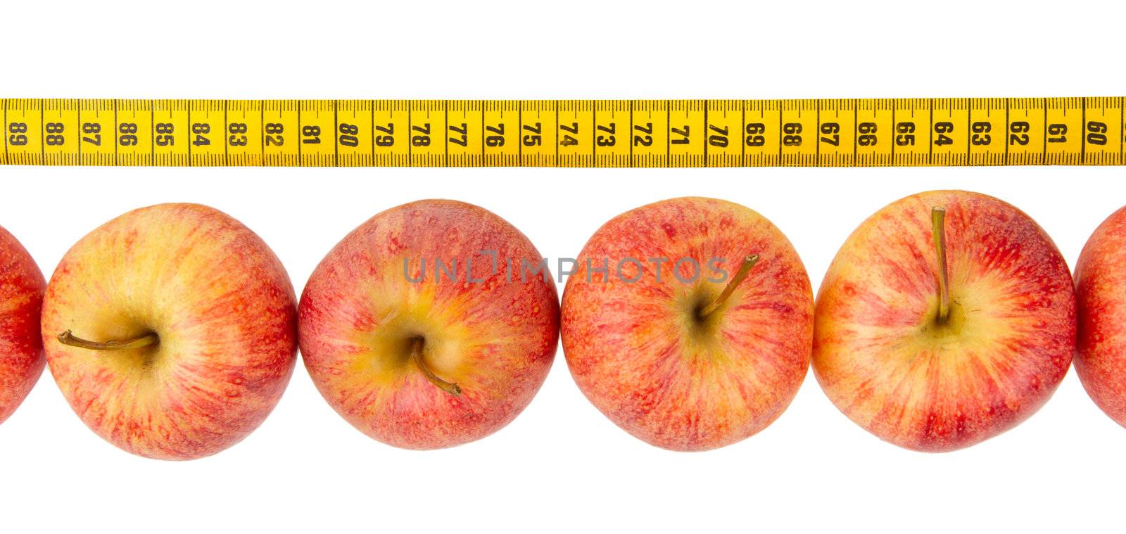 Apple diet, red apples with a yellow tape-measure