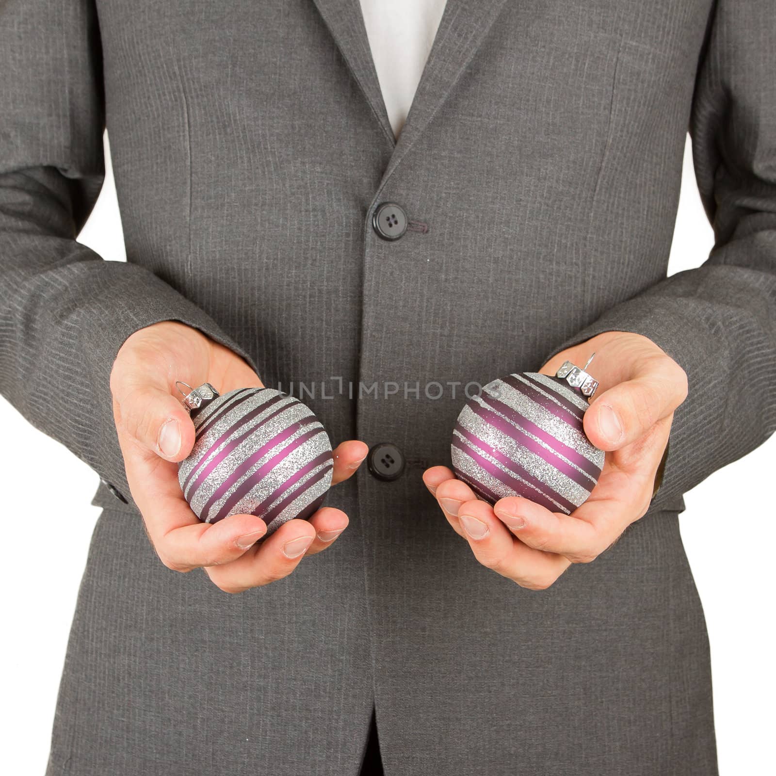 Man in grey suit is holding Christmass balls, isolated