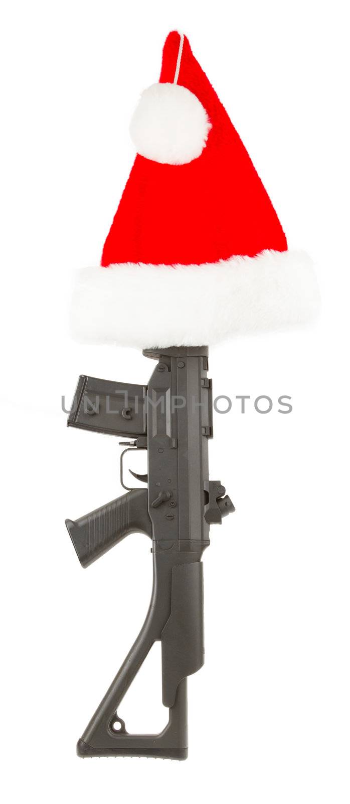 Weapon (firearm) concealed in santas hat, isolated on canvas