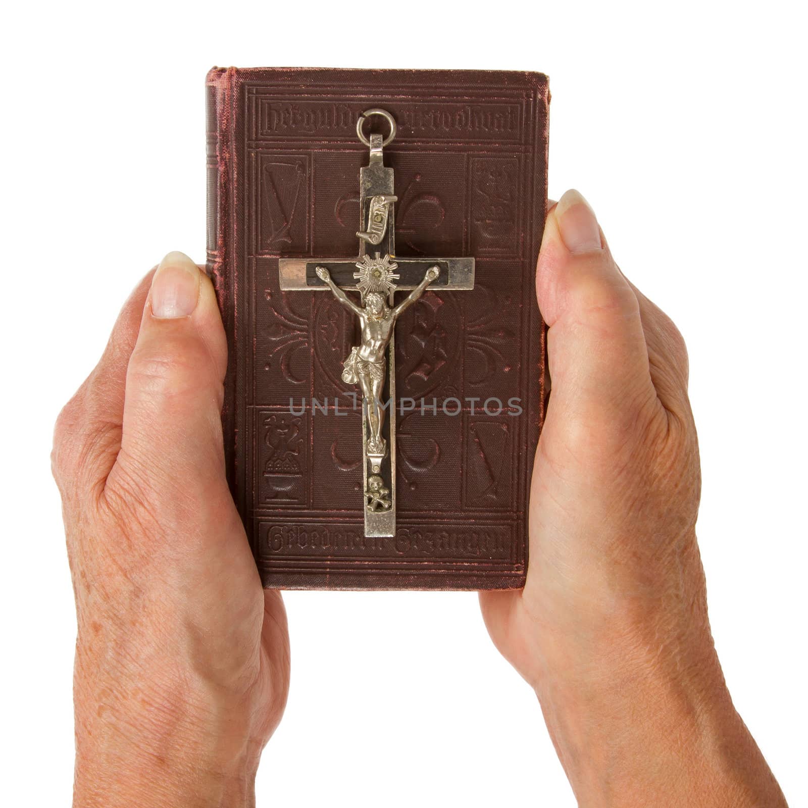 Old hands (woman) holding a very old bible, isolated on white