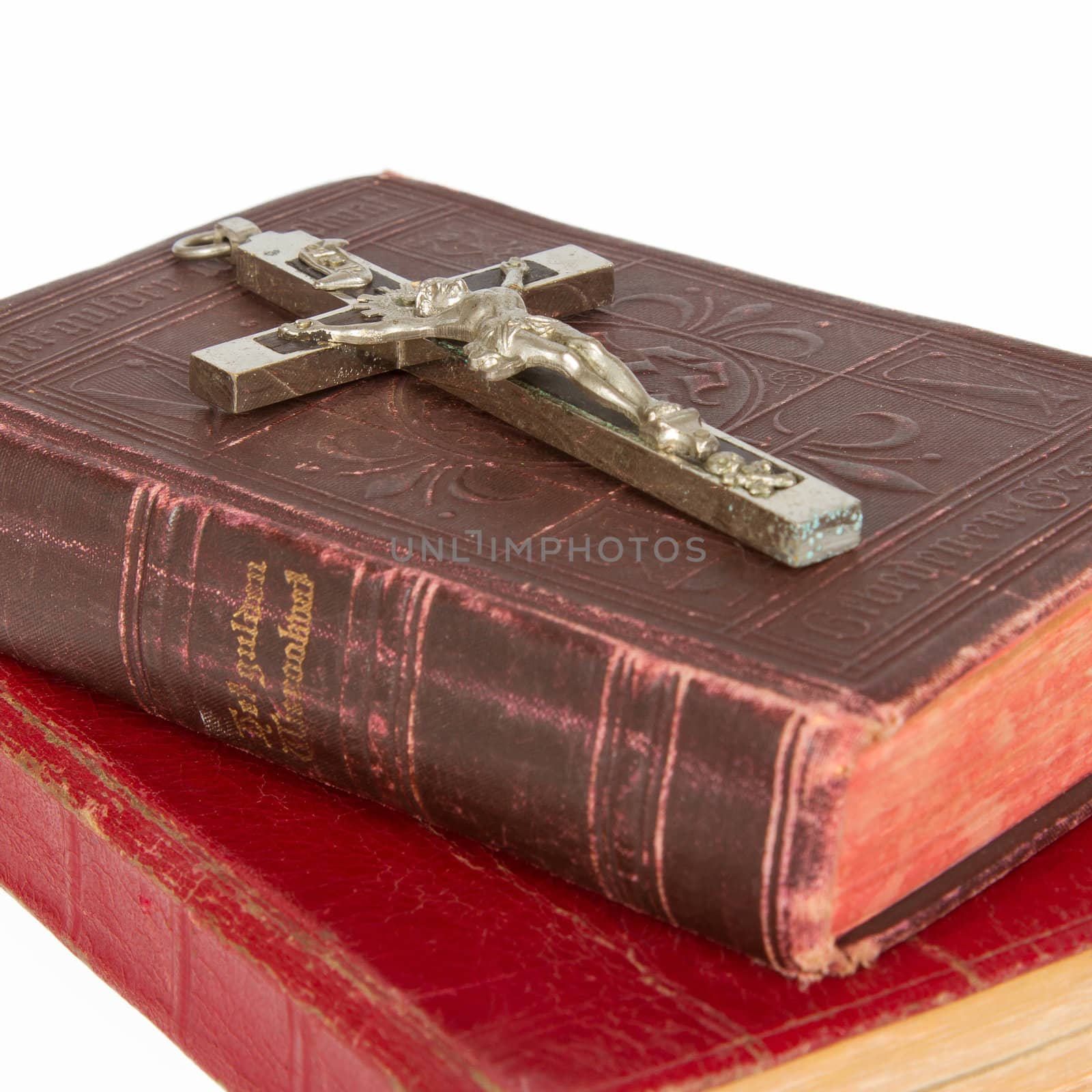 Old antique bible and cross on a white background, isolated