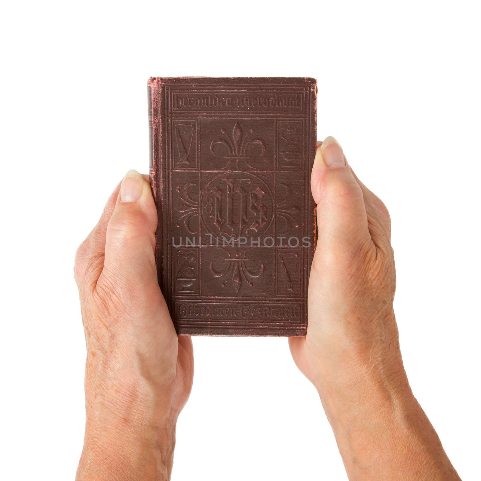 Old hands (woman) holding a very old bible, isolated on white