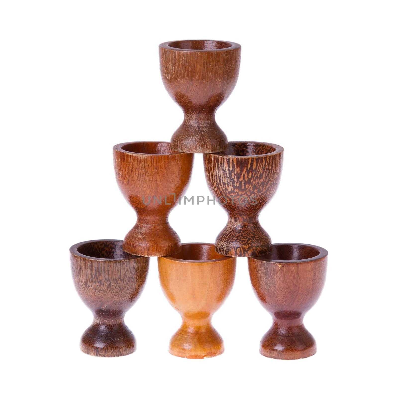 Set of different wooden egg cups isolated on white