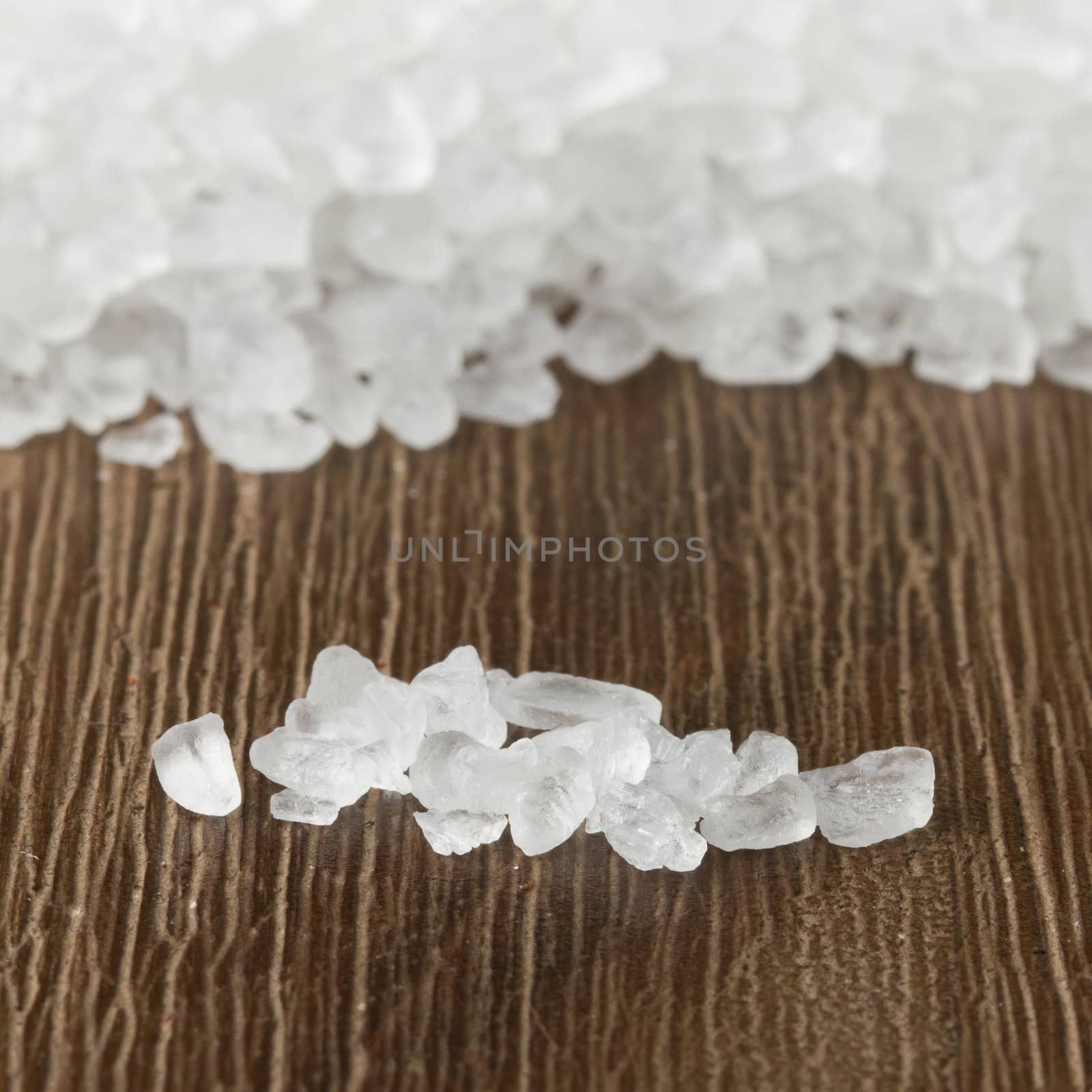 Heap of salt on isolated wood background