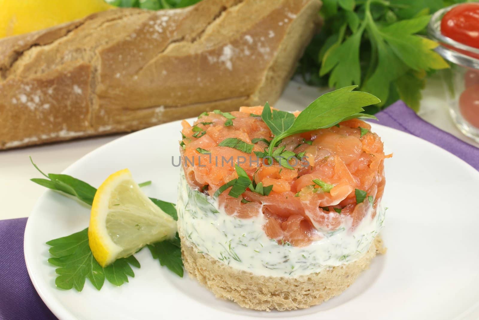 a slice of bread with herb cream and salmon tartare