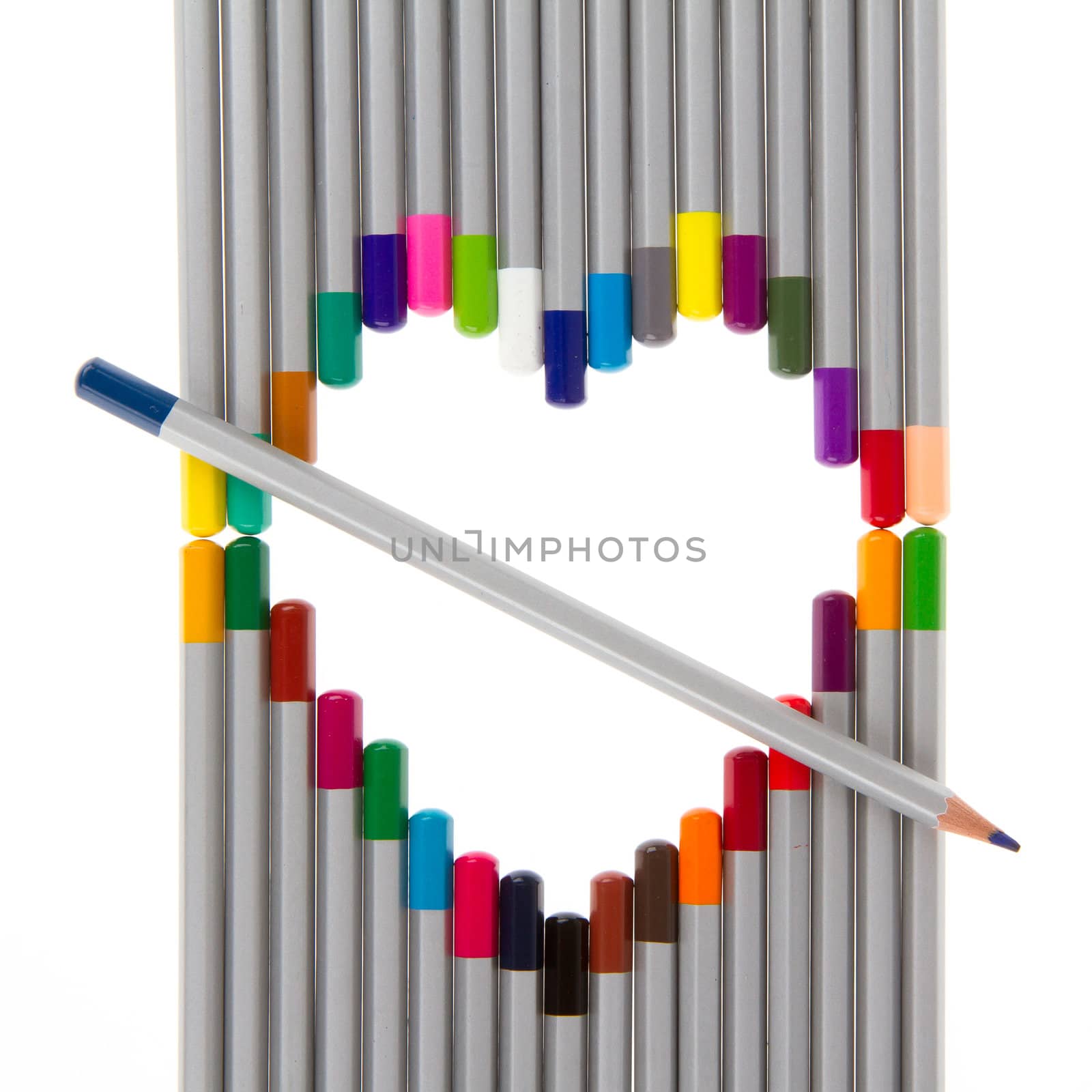 Many different color pencils on white background, heart frame