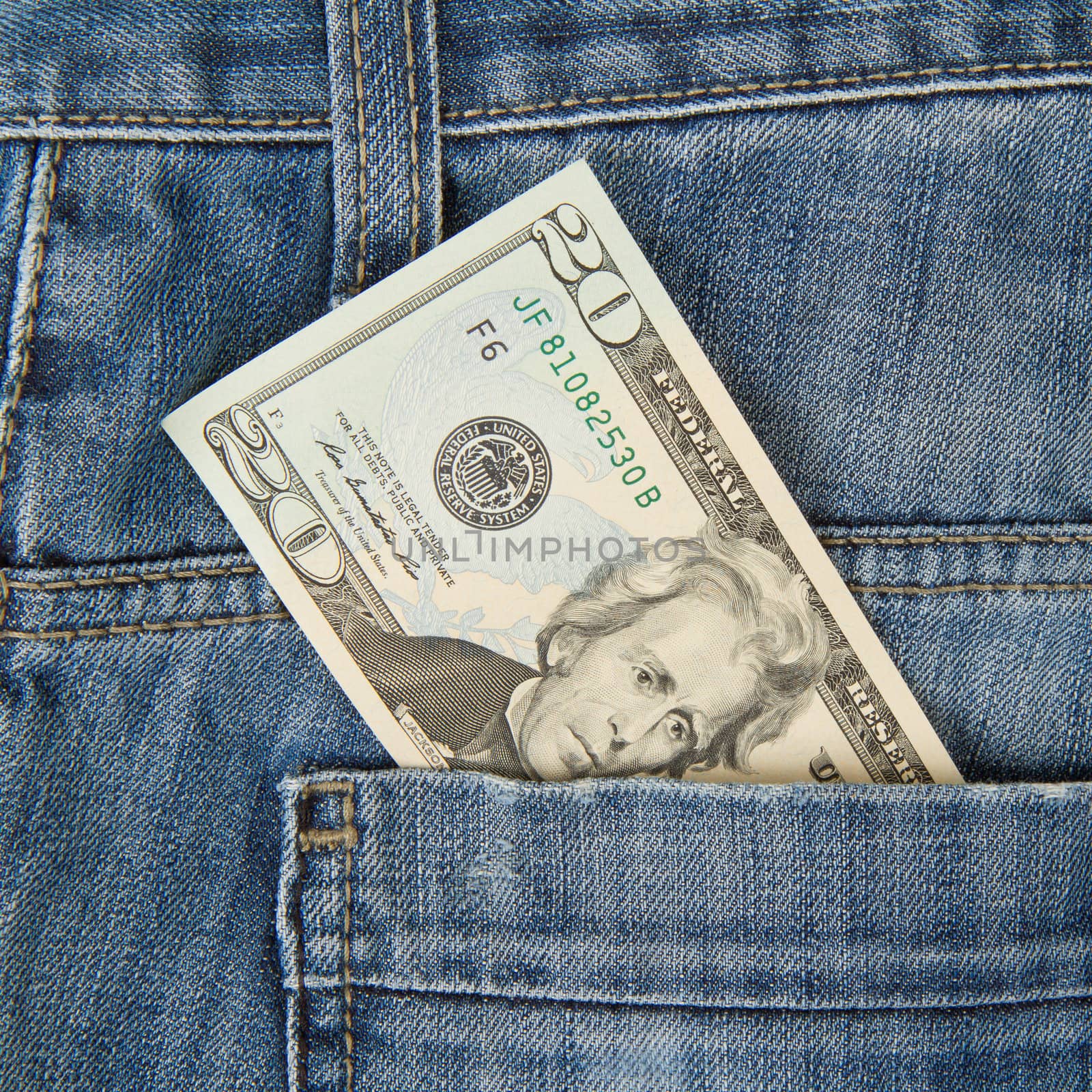 Macro shot of trendy jeans with american 20 dollar bill by michaklootwijk