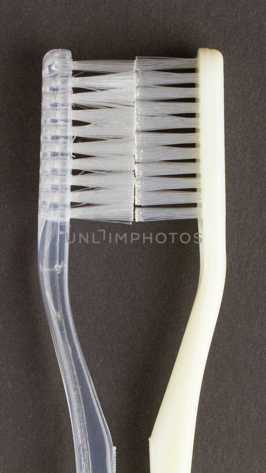 Two white toothbrushes isolated on a black background