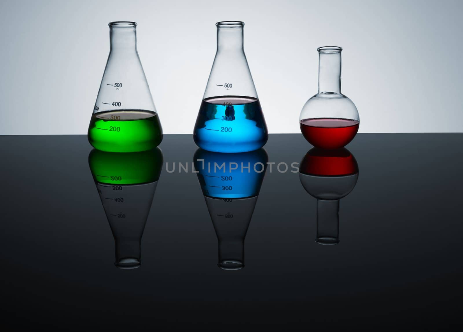 laboratory test tubes with colored liquid, place for text