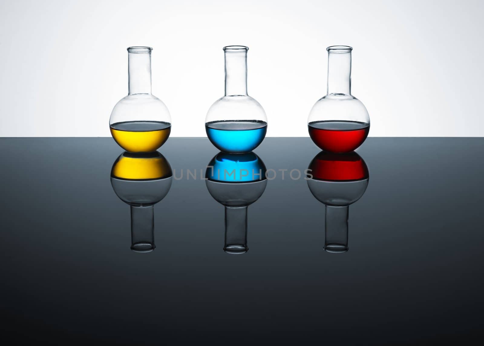 laboratory test tubes with colored liquid, place for text