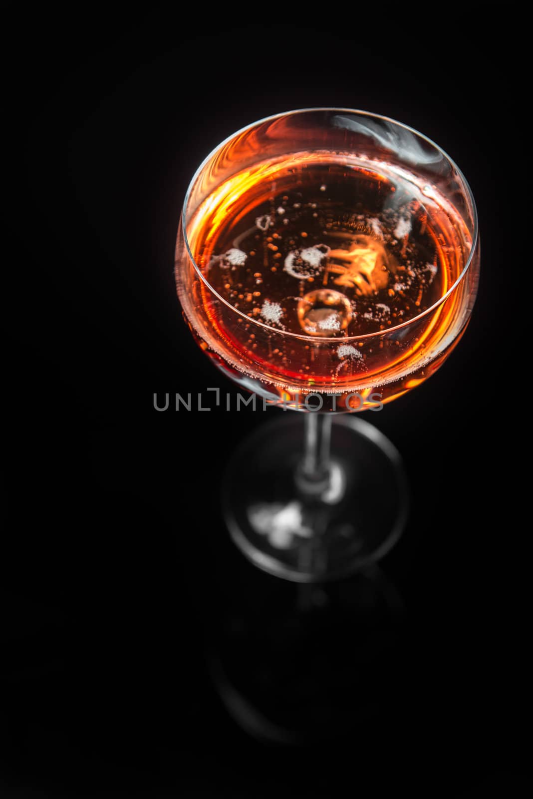 Red wine poured into translucent wine glass