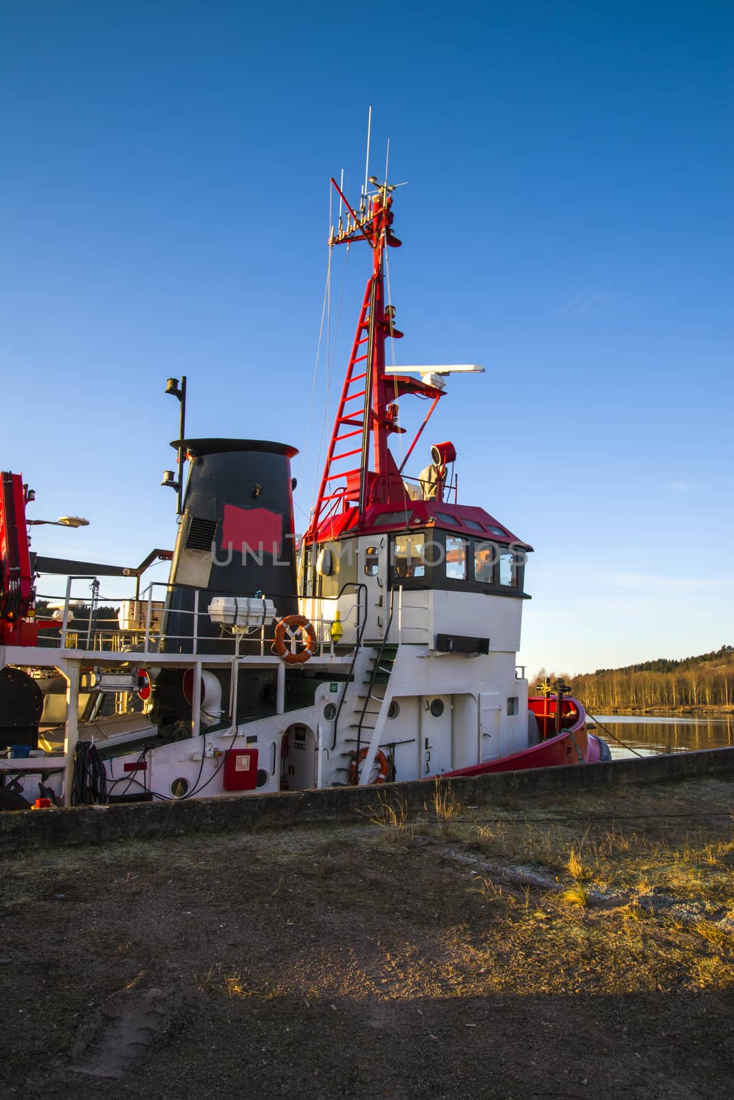 tug frier is moored to the quay at the port of halden, image is shot in december 2012.