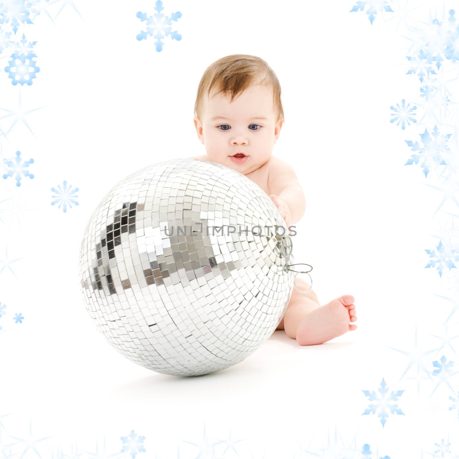 adorable baby boy with big disco ball and snowflakes