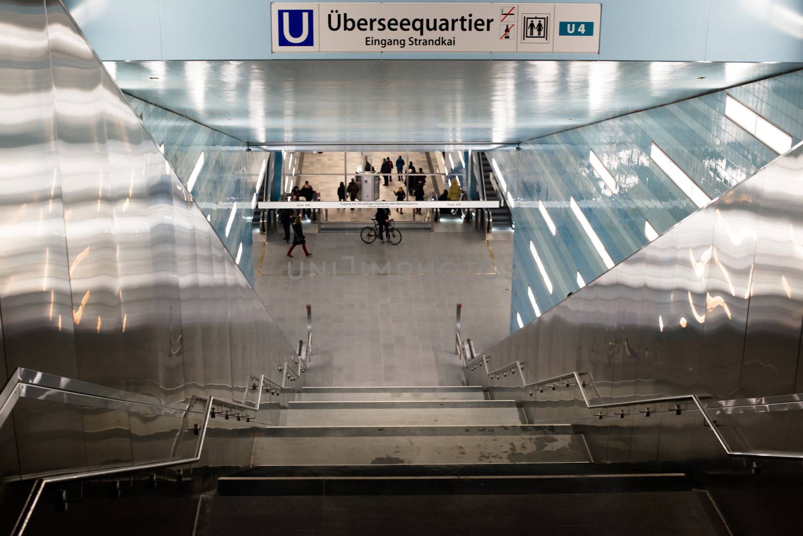 HAMBURG - DECEMBER 2, 2012: First passengers are using the new underground station “Überseequartier” in Hamburg Hafencity on December 2, 2012 in Hamburg Germany. The station connects the exciting newly built area of Hafencity with the rest of Hamburg – currently the public can test drive the line for free before the station is officially connected with the timetable of the underground.